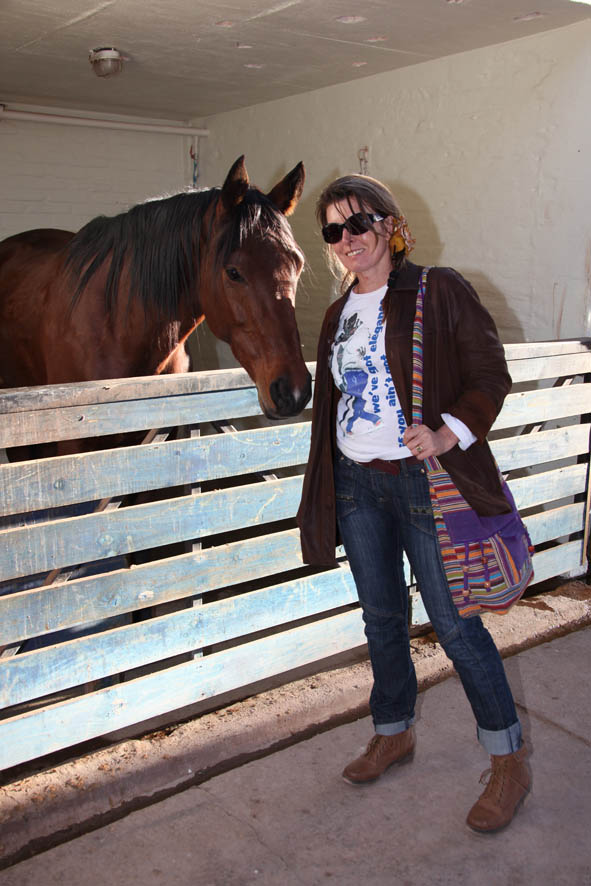The writer making friends with one of the beautiful horses on the property